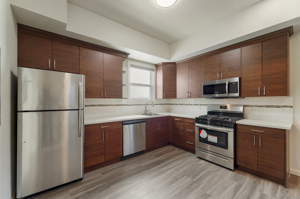 A kitchen with wooden cabinets and stainless steel appliances.