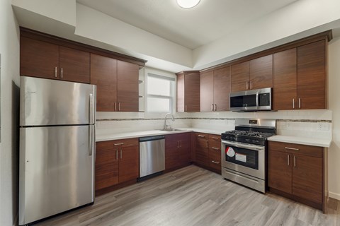 A kitchen with wooden cabinets and stainless steel appliances.