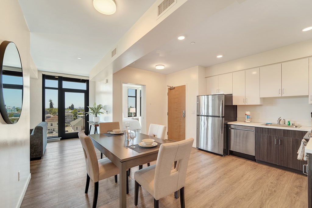 A modern kitchen with a dining table and chairs.