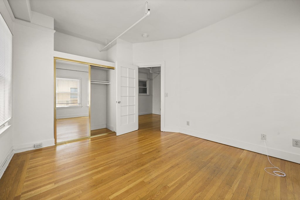 A room with wooden floors and white walls.