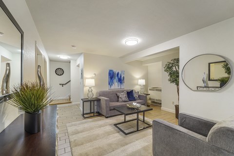 A living room with a grey couch and a coffee table.