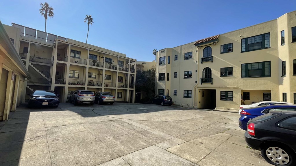 a parking lot in front of an apartment building
