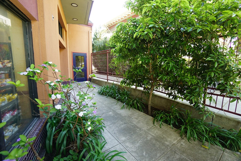 A blue door is on the left side of a building.