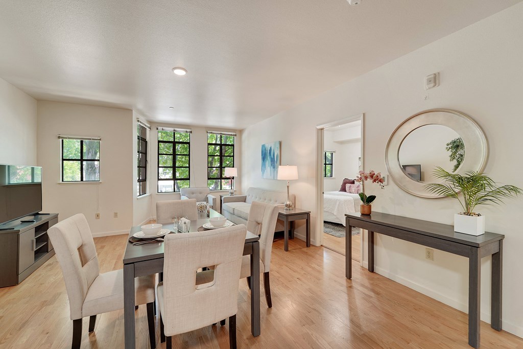 A dining room with a table set for six.