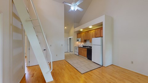 A white refrigerator is in a kitchen with wooden cabinets.