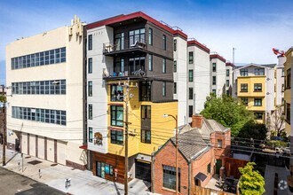 a yellow and white building sitting next to a white building