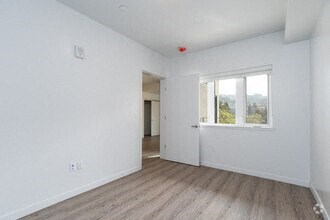 an empty room with a window and a door