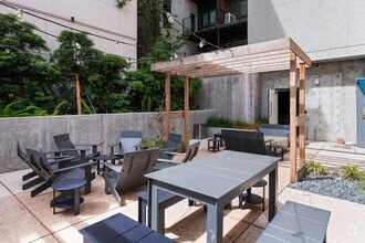 a patio with a table and chairs and a pergola