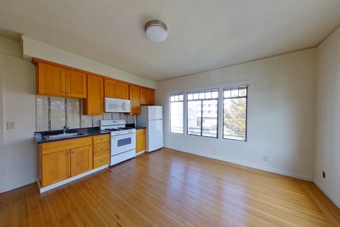 A kitchen with wooden cabinets and a black countertop.