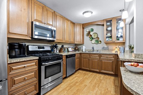 a kitchen with stainless steel appliances and wooden cabinets