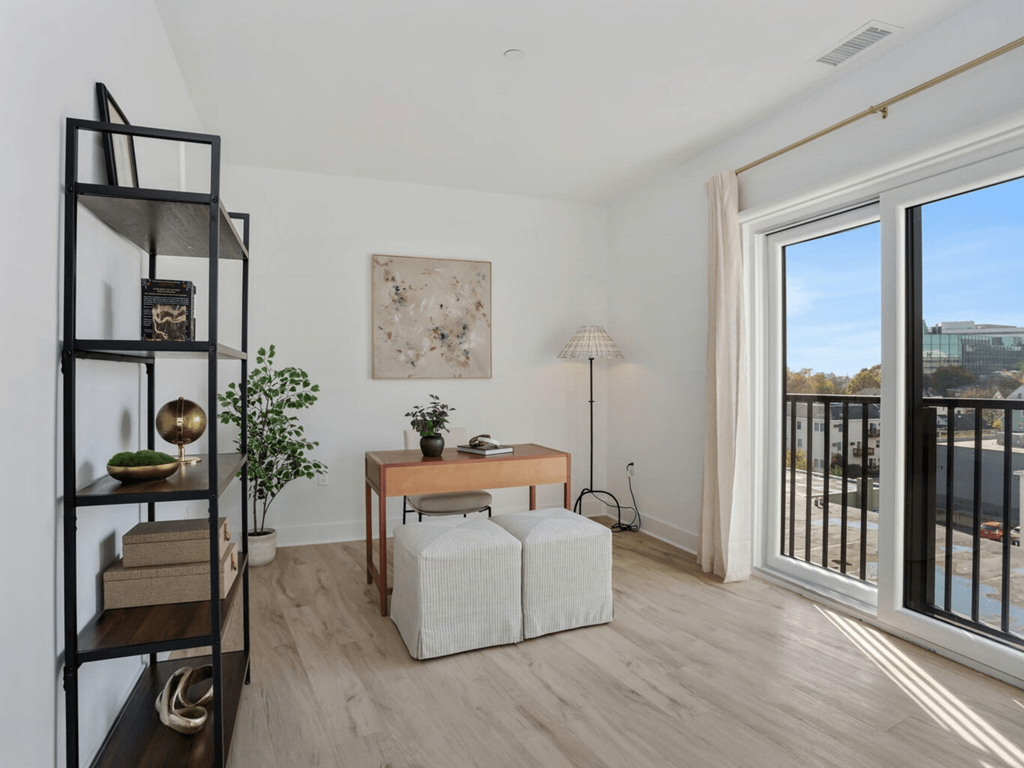 a living room with a large glass door and a balcony