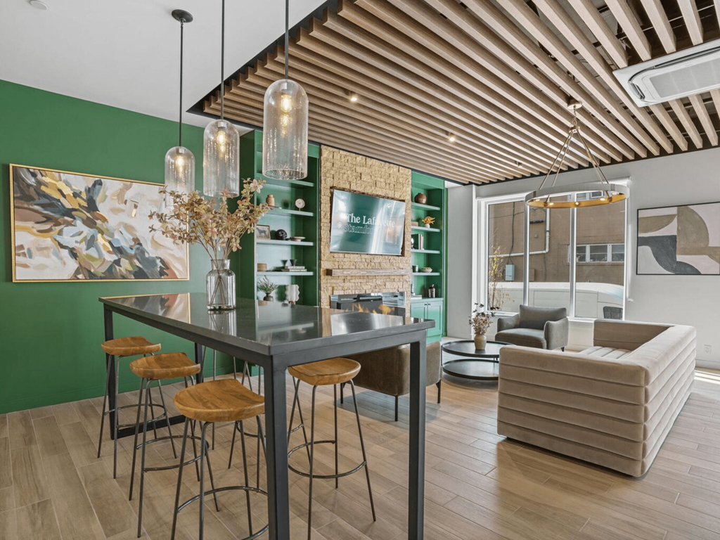 a dining area with a table and chairs and a living room with a couch