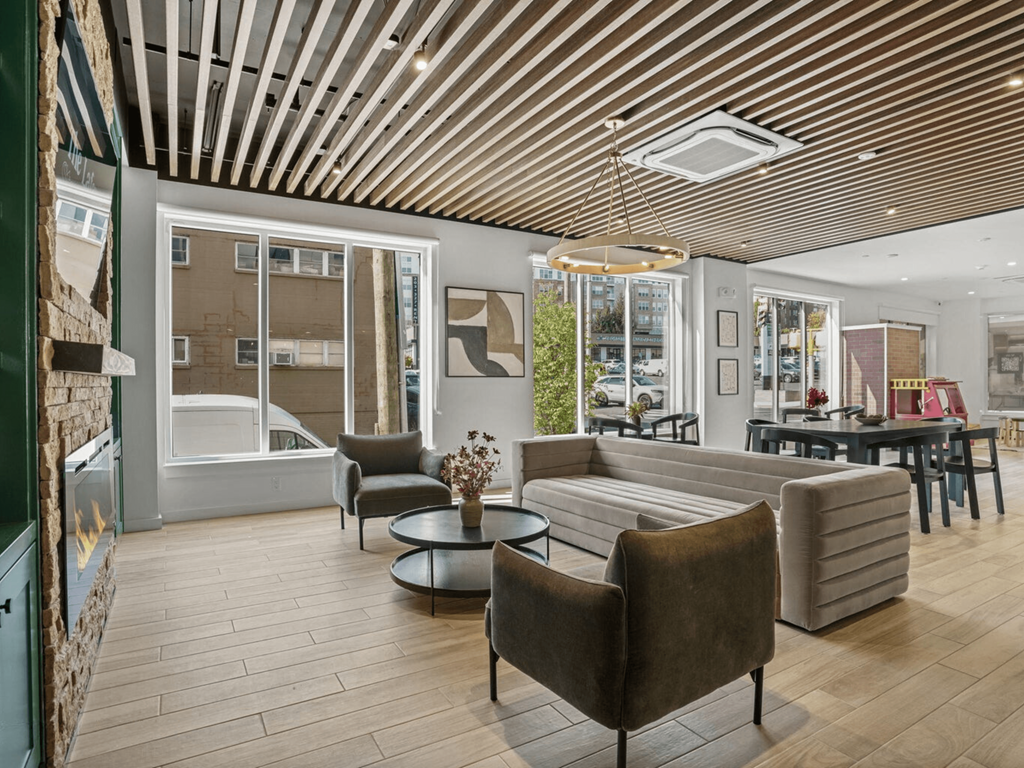 a living room with couches and chairs and a tub