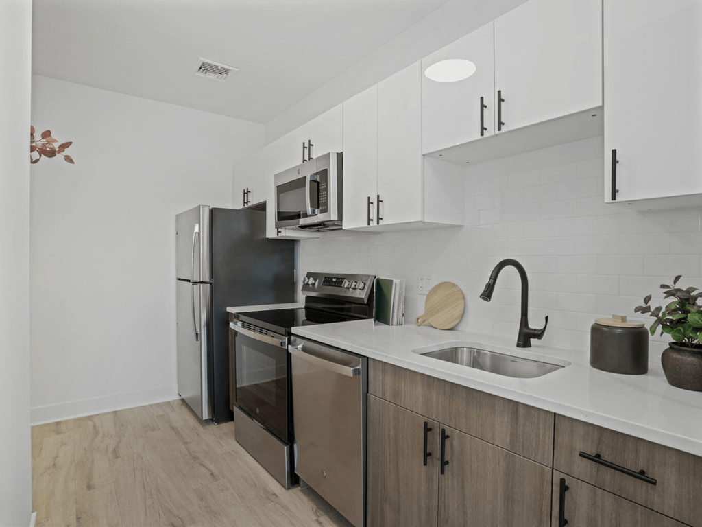 a kitchen with stainless steel appliances and white cabinets