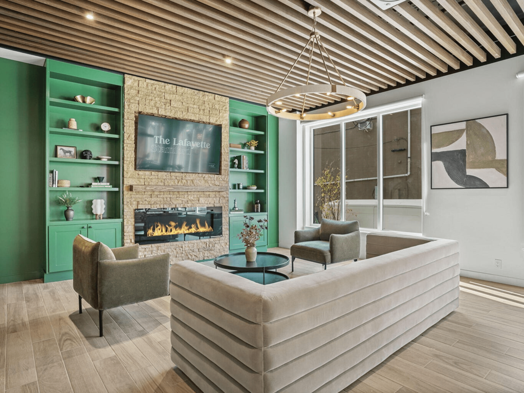 a living room with a couch and chairs and a fireplace