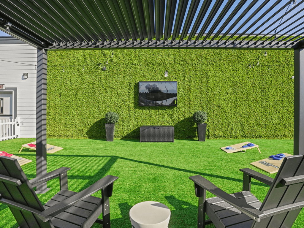 a patio with chairs and a tv on the wall