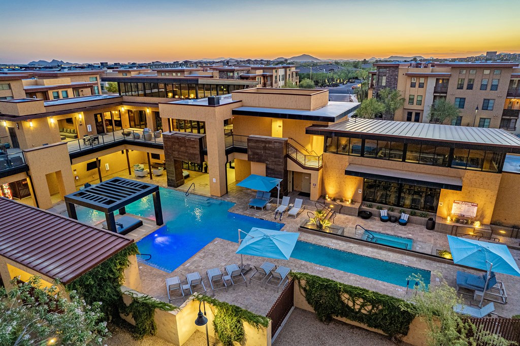 an aerial view of a resort with a swimming pool