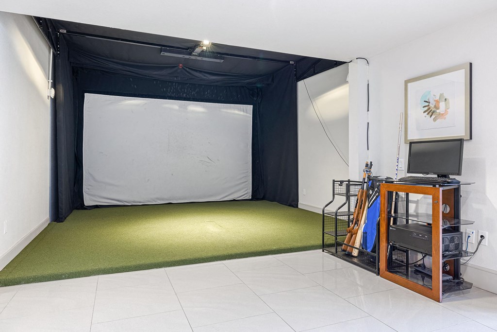 an empty room with a projector and a screen on the floor