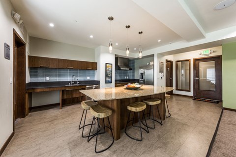 A kitchen with a bar area and a refrigerator.