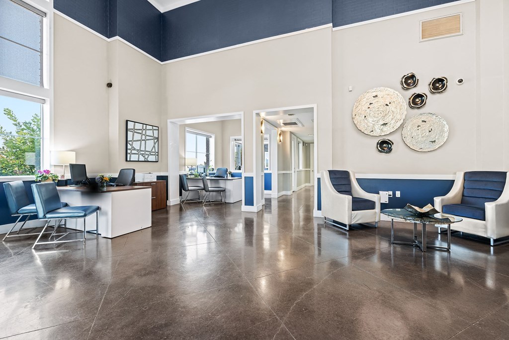 a lobby with blue and white furniture and a reception area