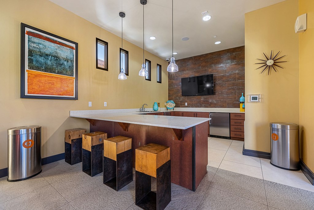 a kitchen with a bar and stools
