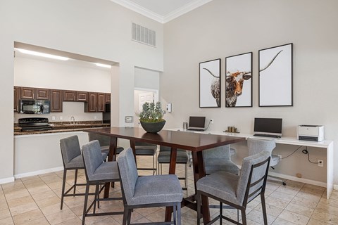 A dining room with a table and chairs.