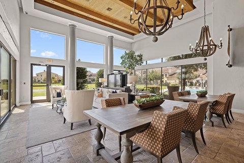 A dining room with a table and chairs.