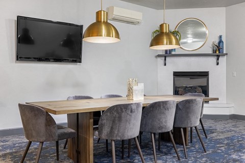 a dining room with a wooden table and chairs and a fireplace