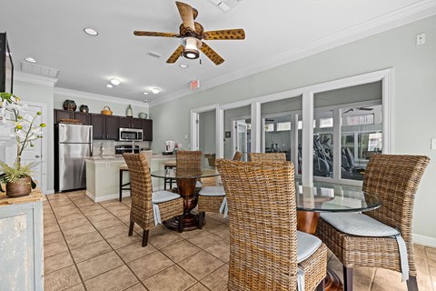 A kitchen with a dining table and chairs.