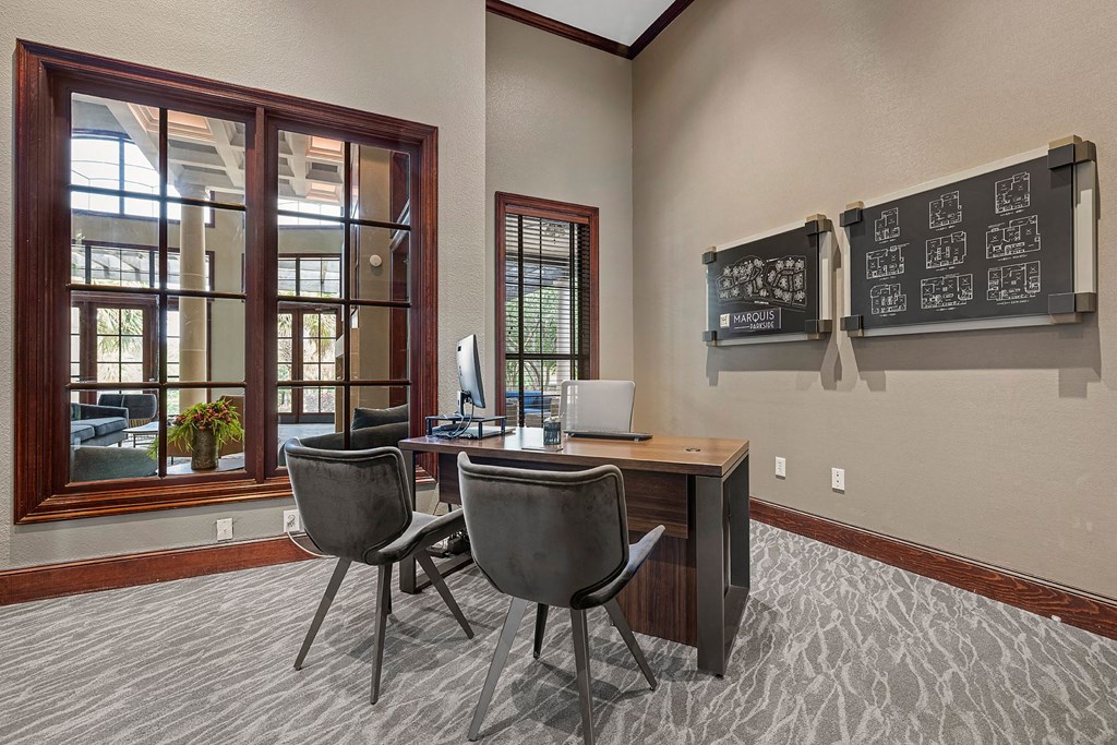A room with a desk and two chairs.