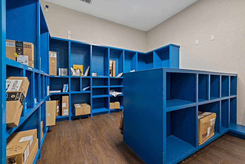 A room with blue shelving units filled with boxes.