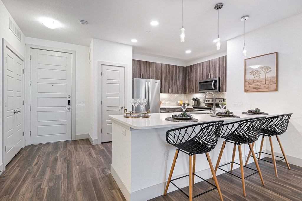 a kitchen with an island with bar stools