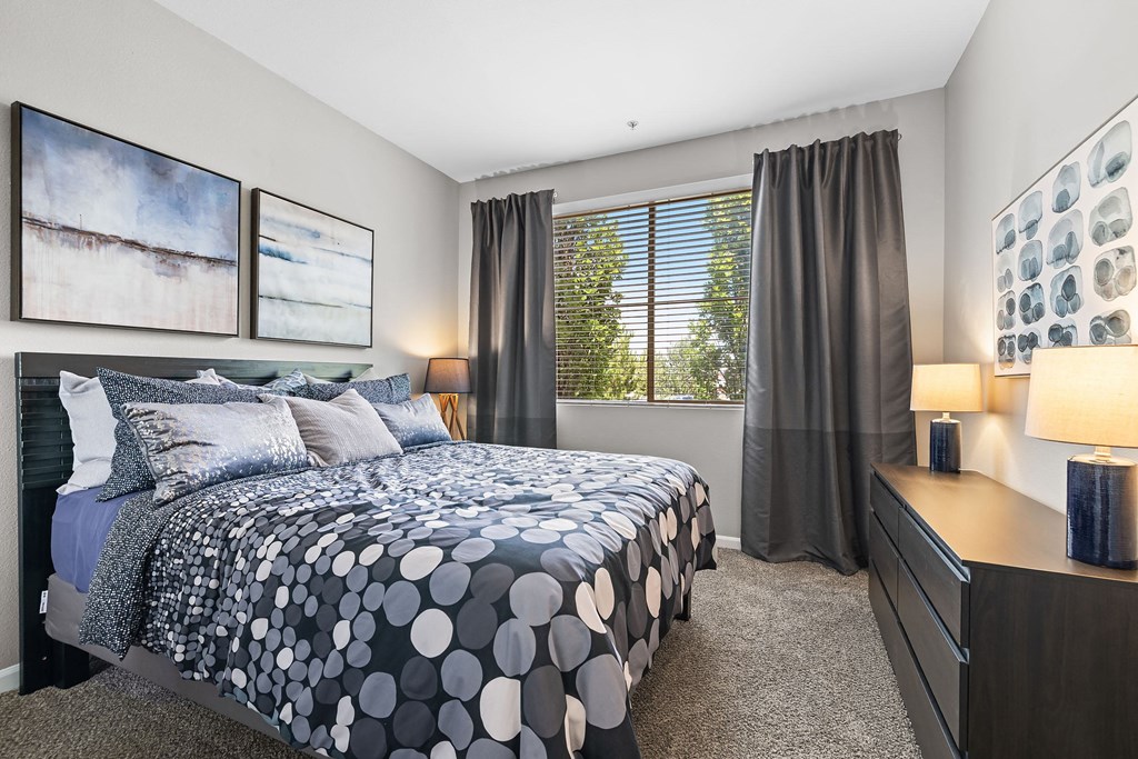 a bedroom with a large bed and a window