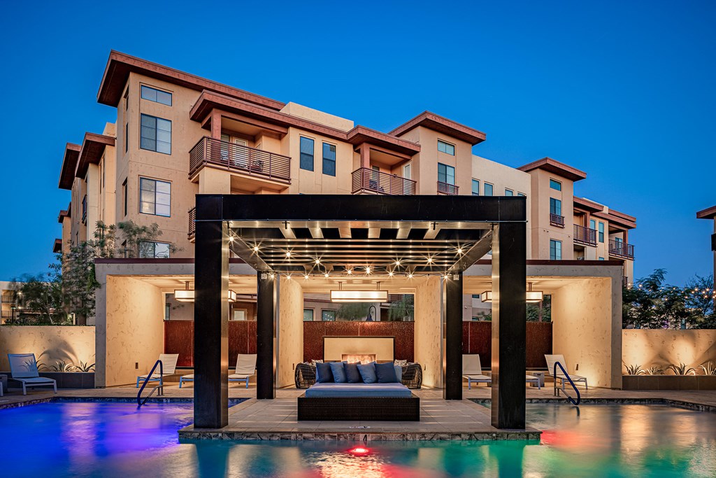 a swimming pool with a couch in front of a building