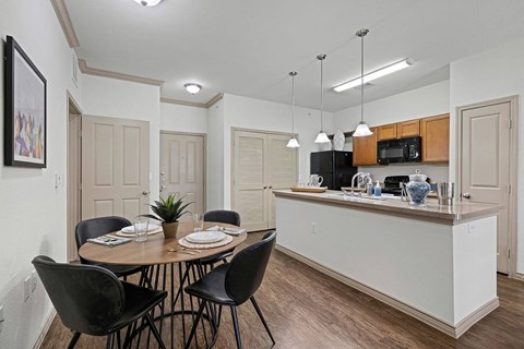 A kitchen with a dining table set for four.