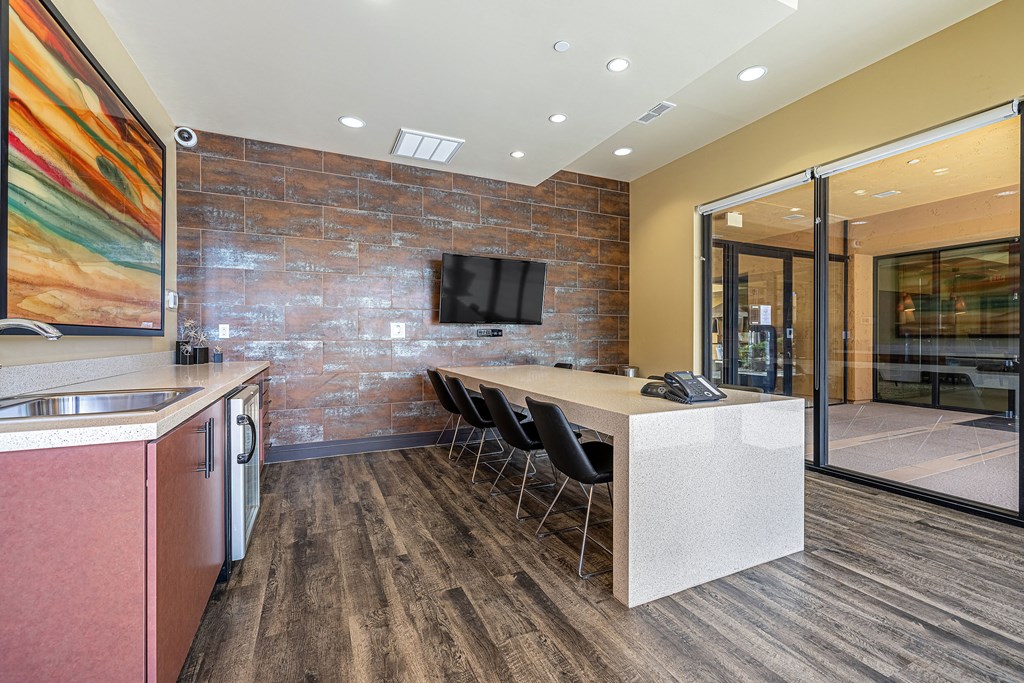 a kitchen with a counter and a table with chairs