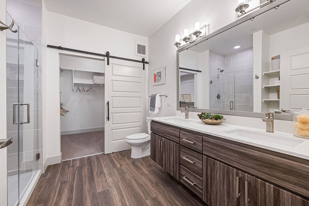a bathroom with a shower and a sink and a toilet