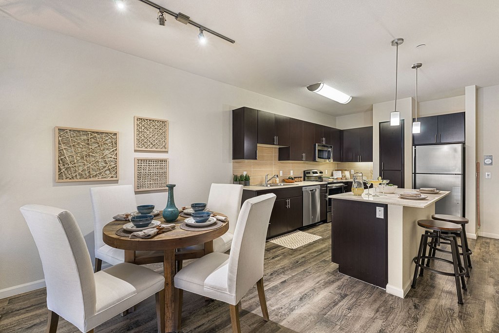 an open kitchen and dining area with a table and chairs