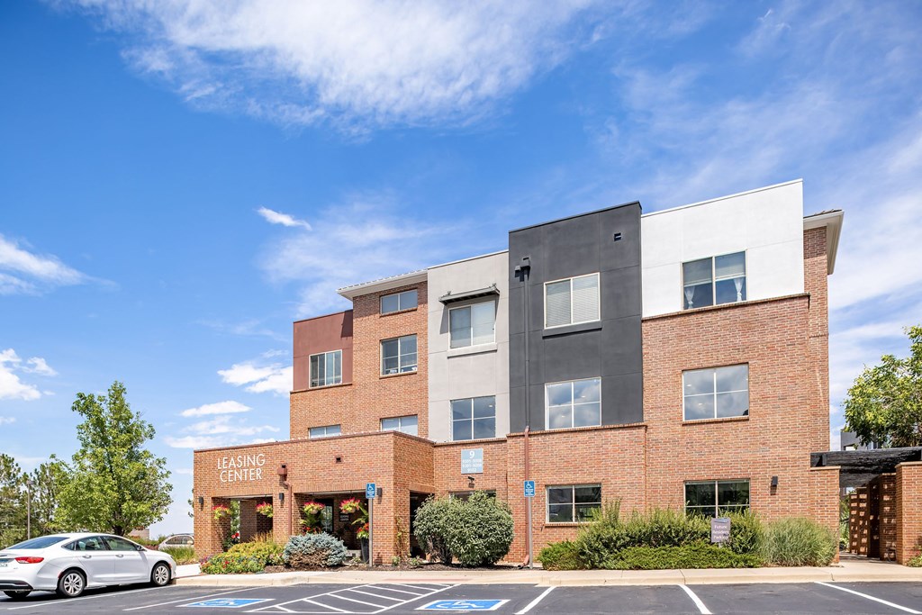 a brick building with a white car parked in front of it