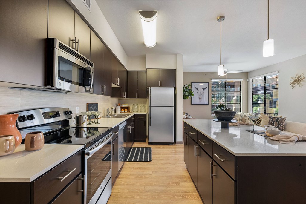 a kitchen with stainless steel appliances and a large counter top