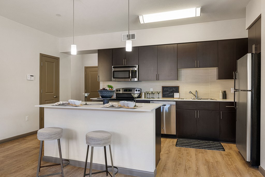 a kitchen with a island and two stools