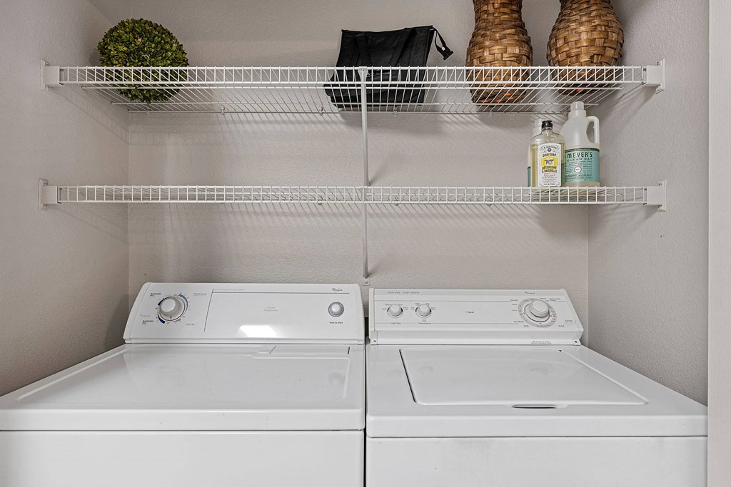 A white washing machine and dryer in a laundry room.