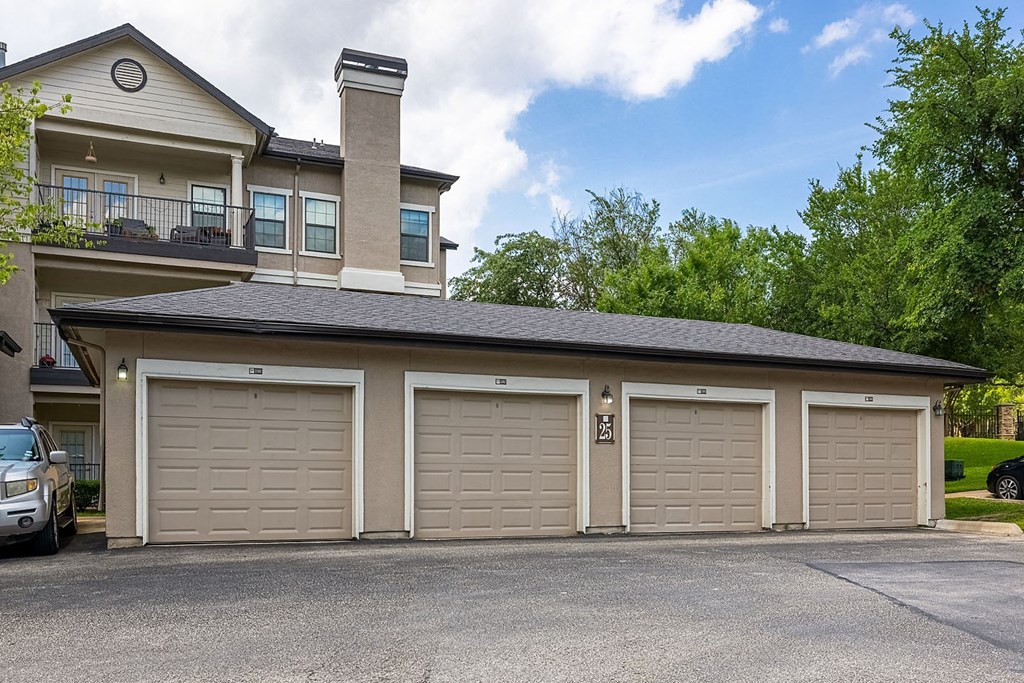 A house with a garage and a car parked in front.