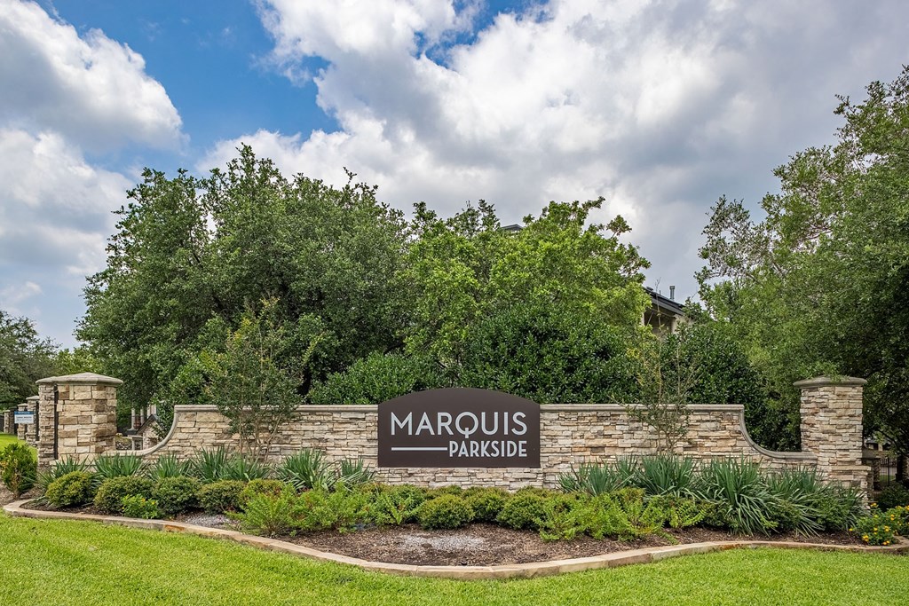 A sign that says "Marquis Parkside" is in front of a grassy area.