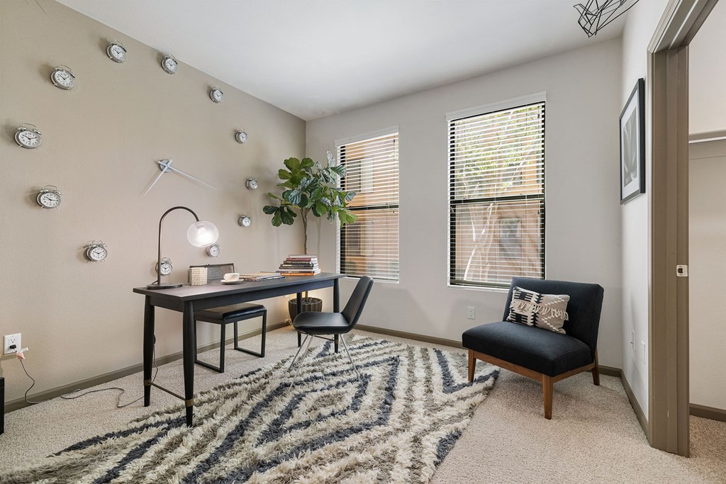 an office with a desk and a chair and a window