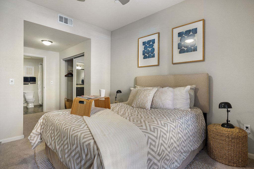 a bedroom with a large bed and a bathroom