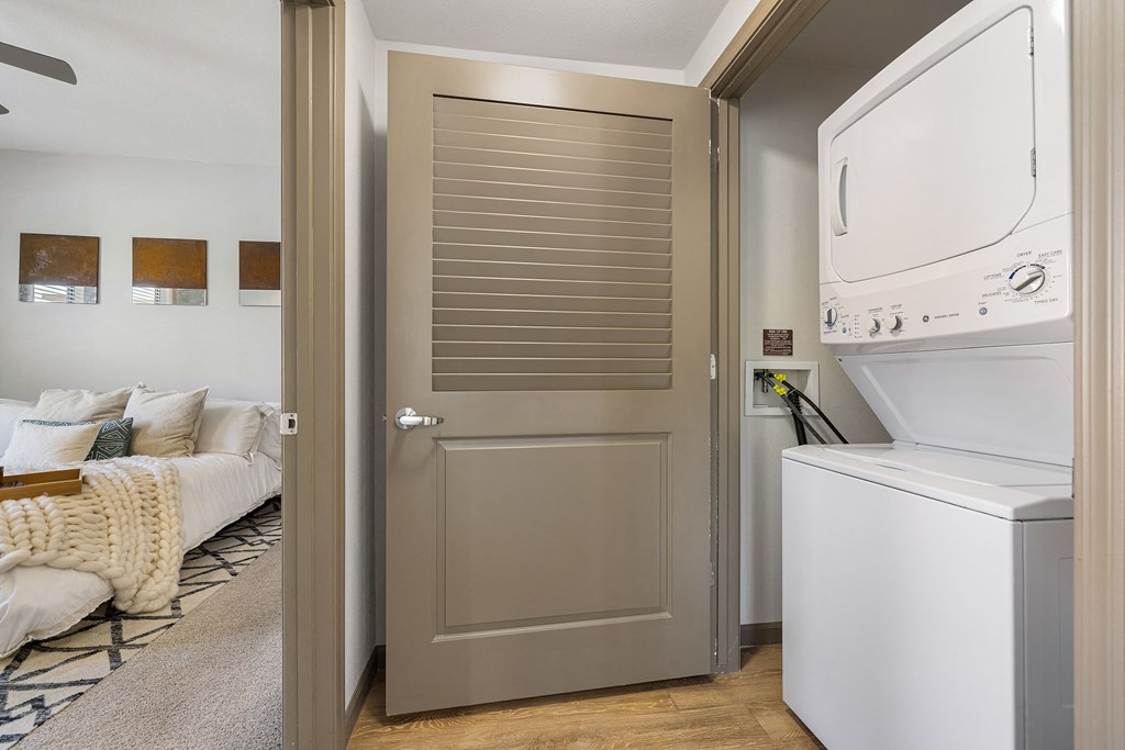 a laundry room with a washer and dryer next to a door