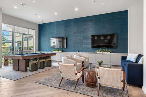 a game room with a pool table and a television