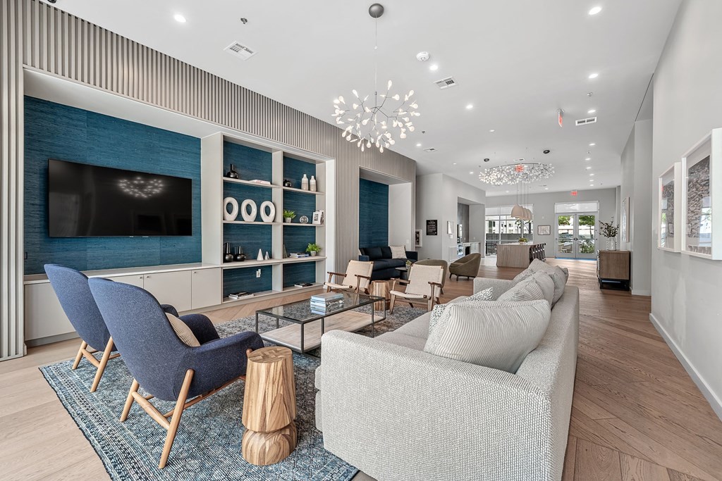 a living room with couches and chairs and a television