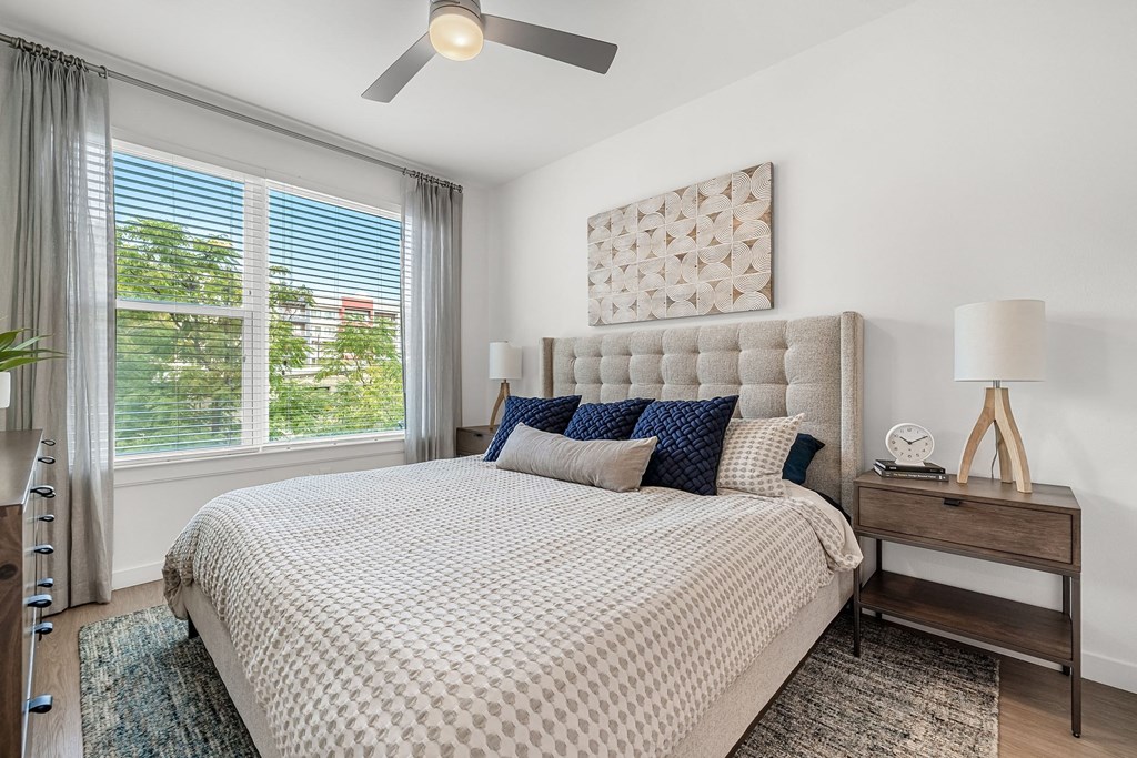 a bedroom with a bed and a ceiling fan